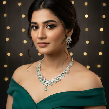 Elegant silver-toned mint crystal leaf necklace set with matching earrings, priced Rs. 2950