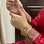 Close-up of hands with jewelry against a neutral background