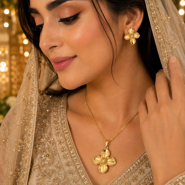 Golden four-petal floral necklace with matching earrings