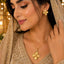 Golden four-petal floral necklace with matching earrings