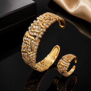 Golden CZ designer bracelet and matching ring set with intricate detailing