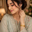 Gold-Tone Engraved Chevron & Medallion Wide Cuff Bangle Bracelet worn by model in Pakistani sage green formal attire