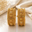 Gold-Tone Mughal Temple Granule Polki & Ruby CZ Wide Kada Bangle Set of 2 showing front and side panel detail on cream marble surface with baby's breath flowers backdrop