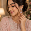 Woman wearing silver-tone pink CZ teardrop marquise leaf wing drop earrings styled with a blush pink embroidered Pakistani formal outfit