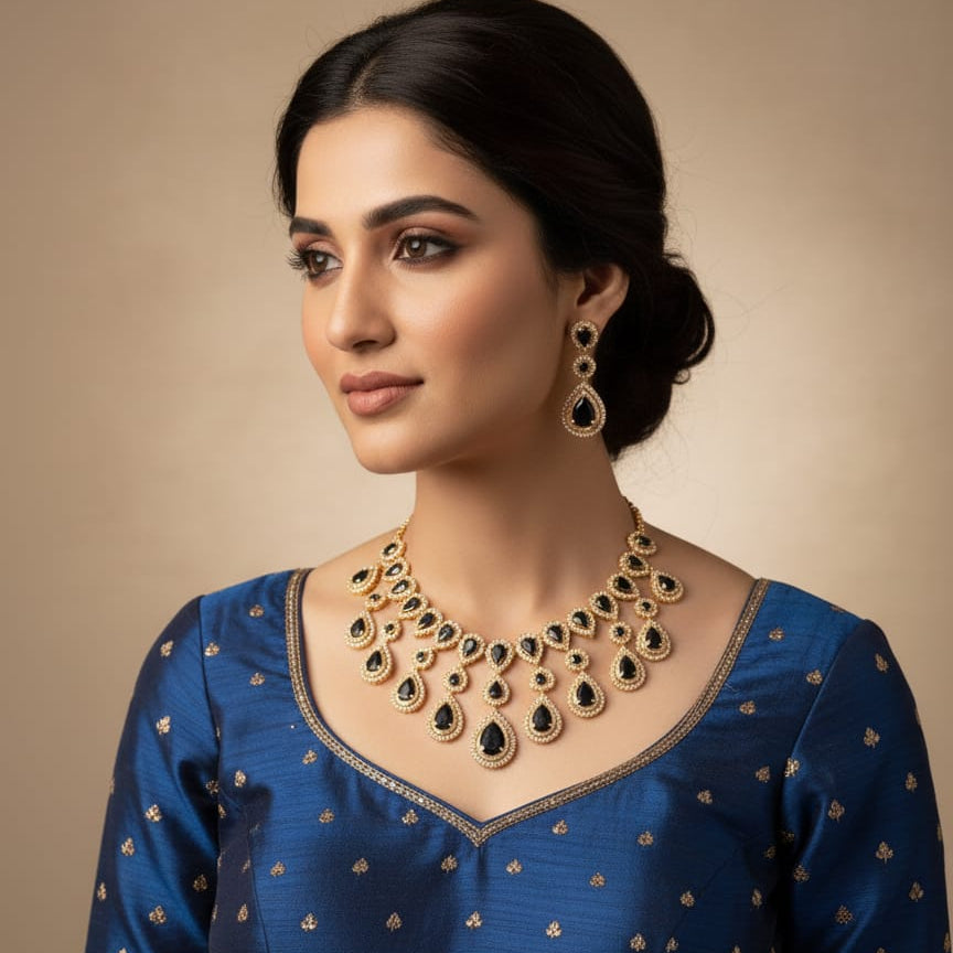Woman wearing a gold necklace and earrings on a beige background