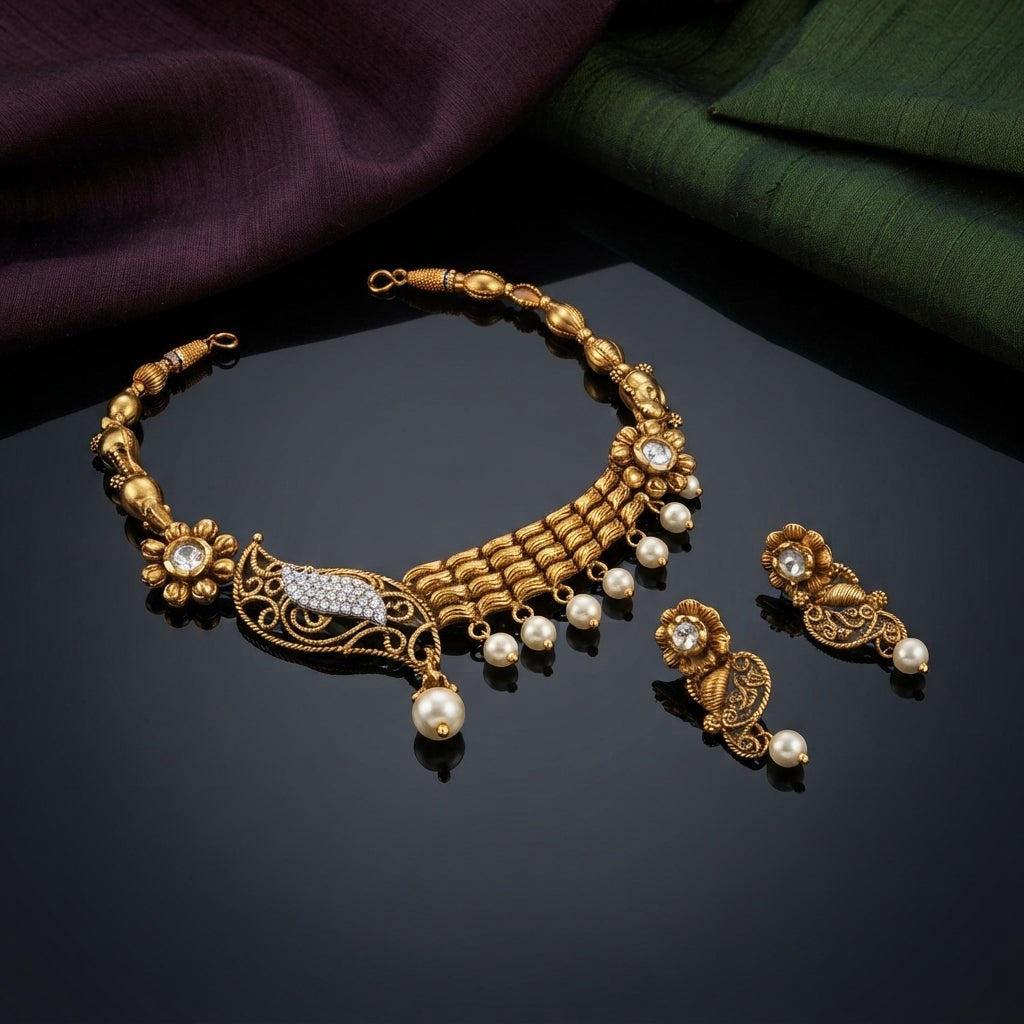 Antique Gold Filigree Peacock CZ Pearl Choker Necklace Earrings Set on dark grey mirror surface with purple and green silk fabric backdrop showing alternating oval bead granulation chain with ribbed gold bar bib panels and pearl drop fringe filigree peacock arabesque pendant with micro-pave CZ marquise and kundan flower top alongside matching drop earrings with mirror reflections below