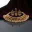 Antique Gold Kundan Polki Pearl Bridal Choker Jhumka Earrings Tikka Set on dark grey mirror surface with burgundy velvet backdrop showing wide 3-row antique gold kundan polki choker with multicolor CZ cups and dense faux pearl drop fringe alongside triple kundan jhumka earrings with mini gold bells and pearl fringe and matching maang tikka with mirror reflections below