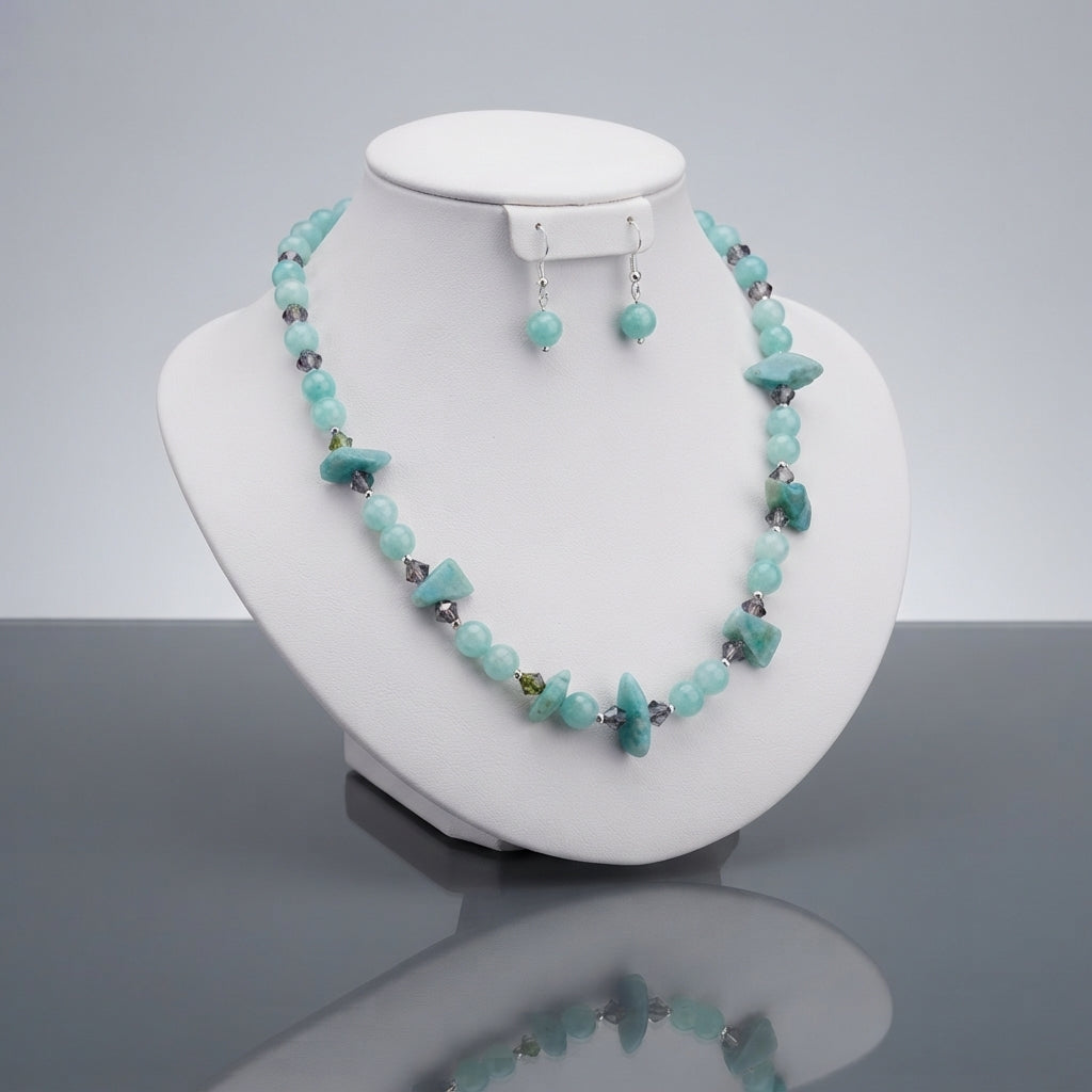 Aqua-tone beaded necklace with irregular chip-shaped pieces and matching bead drop earrings displayed together.