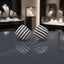 Pair of rounded-square stud earrings with alternating black and clear-looking rows and a silver-tone appearance.