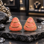 Pair of coral-pink rounded triangular earrings with three curved sections, gold-tone divider lines and borders, and glossy swirled surfaces on dark slate.