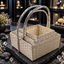 Three graduated cream-coloured woven rectangular baskets nested together, with reflective silver-tone rims and tall matching arch handles.