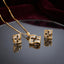 CZ Baguette Cross Concave Square Pendant Necklace and Earrings Set in Gold Emerald — 22K gold concave square pendant and stud earrings with deep vivid emerald green princess-cut CZ cross and white baguette CZ fill on burgundy velvet backdrop