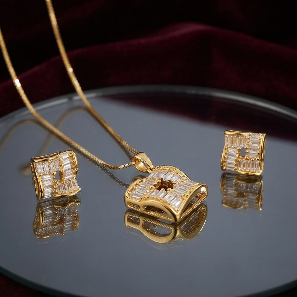 CZ Baguette Cross Concave Square Pendant Necklace and Earrings Set in Gold Ruby — 22K gold concave square pendant and stud earrings with deep ruby red princess-cut CZ cross and white baguette CZ fill on dark charcoal silk backdrop