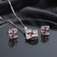 CZ Baguette Cross Concave Square Pendant Necklace and Earrings Set in Silver Sapphire — rhodium silver concave square pendant and stud earrings with deep navy sapphire blue princess-cut CZ cross and white baguette CZ fill on dark charcoal silk backdrop