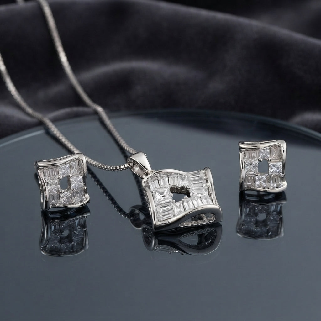 CZ Baguette Cross Concave Square Pendant Necklace and Earrings Set in Silver Ruby — rhodium silver concave square pendant and stud earrings with deep ruby fuchsia pink princess-cut CZ cross and white baguette CZ fill on dark charcoal silk backdrop
