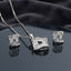 CZ Baguette Cross Concave Square Pendant Necklace and Earrings Set in Silver Ruby — rhodium silver concave square pendant and stud earrings with deep ruby fuchsia pink princess-cut CZ cross and white baguette CZ fill on dark charcoal silk backdrop
