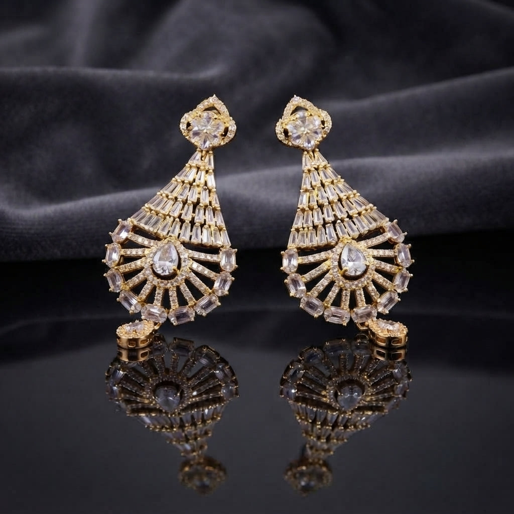 CZ Baguette Fan and Multicolour Sunburst Peacock Drop Earrings in Gold White Diamond on dark mirror surface with charcoal satin backdrop showing 22K gold-tone pair with baguette CZ cone fan open sunburst peacock spoke fan with all-white clear oval CZ accents and white pear CZ halo drop with mirror reflection