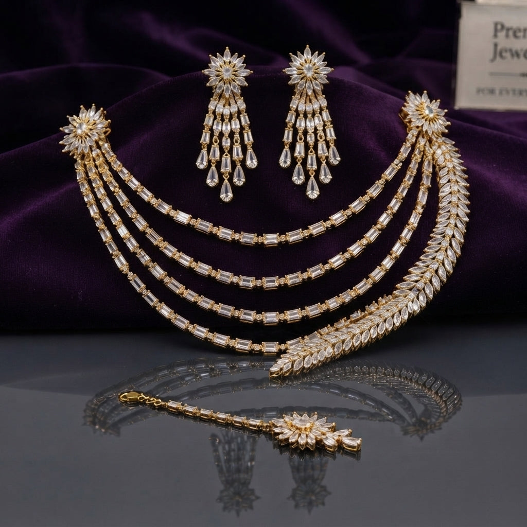 CZ Bridal Multi-Layer Drape Necklace Set with Starburst Brooch in Gold flat lay on dark surface with purple velvet backdrop showing 4-strand draped CZ tennis chains with twin starburst shoulder brooches matching tassel drop earrings and maang tikka in champagne gold-tone with white CZ