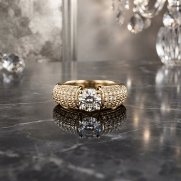 CZ Solitaire Tension Set Wide Triple Row Pavé Band Ring in Gold — 22K warm yellow gold-tone round brilliant white CZ solitaire in open tension bar floating setting on wide triple-row round white CZ micro-pavé tapered band, on dark grey marble mirror surface with crystal chandelier luxury editorial backdrop