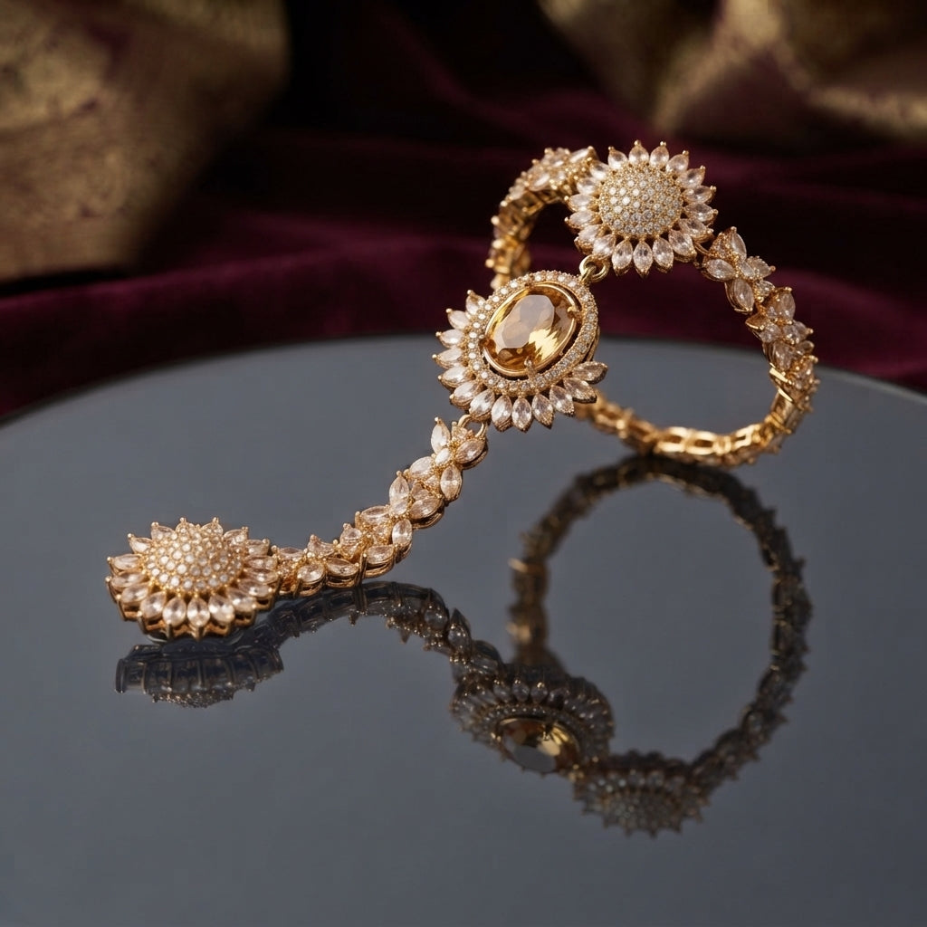 CZ Sunflower Cluster Hath Phool Hand Bracelet Ring Silver lifestyle shot worn on model hand over green velvet cushion with gold brocade fabric showing white CZ sunflower clusters on wrist and connected finger ring in rhodium silver-tone plating