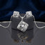 CZ Woven Basket Weave Square Pendant Necklace and Stud Earrings Set in gold-tone flat lay on grey mirror surface with navy blue velvet backdrop showing 2-piece set with tilted square woven basket weave pendant with white CZ micro-pavé border and CZ starburst center and matching square stud earrings with mirror reflection