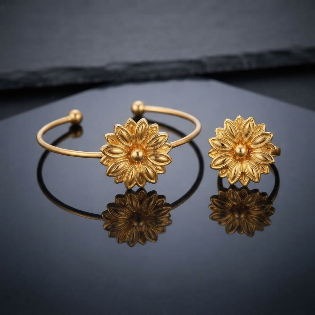 Gold 3D Lotus Dahlia Flower Open Cuff Bangle and Ring Matching Jewelry Set on dark grey slate surface with charcoal backdrop showing 22K warm matte yellow gold-tone open cuff wire bangle lying flat with matching open adjustable ring standing beside it both featuring 3D sculptural multi-layered lotus dahlia flowers with engraved spine petals and raised polished dome centres with mirror reflections below