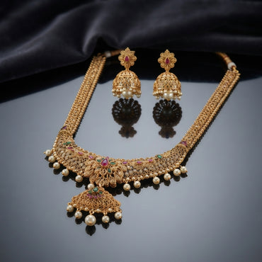 Gold Antique Multi-Color CZ and Pearl Filigree Jhumka Choker Necklace and Earrings Set worn by South Asian female model in burgundy maroon silk saree in luxury jewelry store setting showing full necklace with jhumka dome pendant and pearl drops and matching jhumka earrings