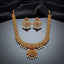 Gold Antique Ruby CZ Filigree Leaf Chain Necklace and Chandbali Earrings Set flat lay on burgundy wine velvet backdrop showing 2-piece set with long graduated filigree leaf-link chain necklace with scattered ruby CZ accents and double-tiered Mughal pendant with pearl fringe drops and matching Chandbali earrings