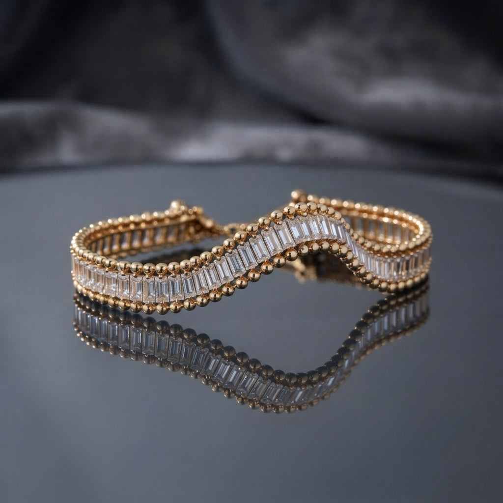 Gold Baguette CZ Channel-Set Double Ball-Edge Wide Tennis Cuff Bracelet flat lay on dark grey mirror surface with dark silk backdrop showing full baguette CZ channel-set center row with double gold ball bead border edges on wide rigid cuff bracelet with mirror reflection below