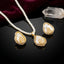 Gold-Tone Baroque Shell Pearl & Seed Pearl Cluster Teardrop Pendant Necklace & Earrings Set on black mirror surface with white crystal quartz and deep burgundy velvet backdrop