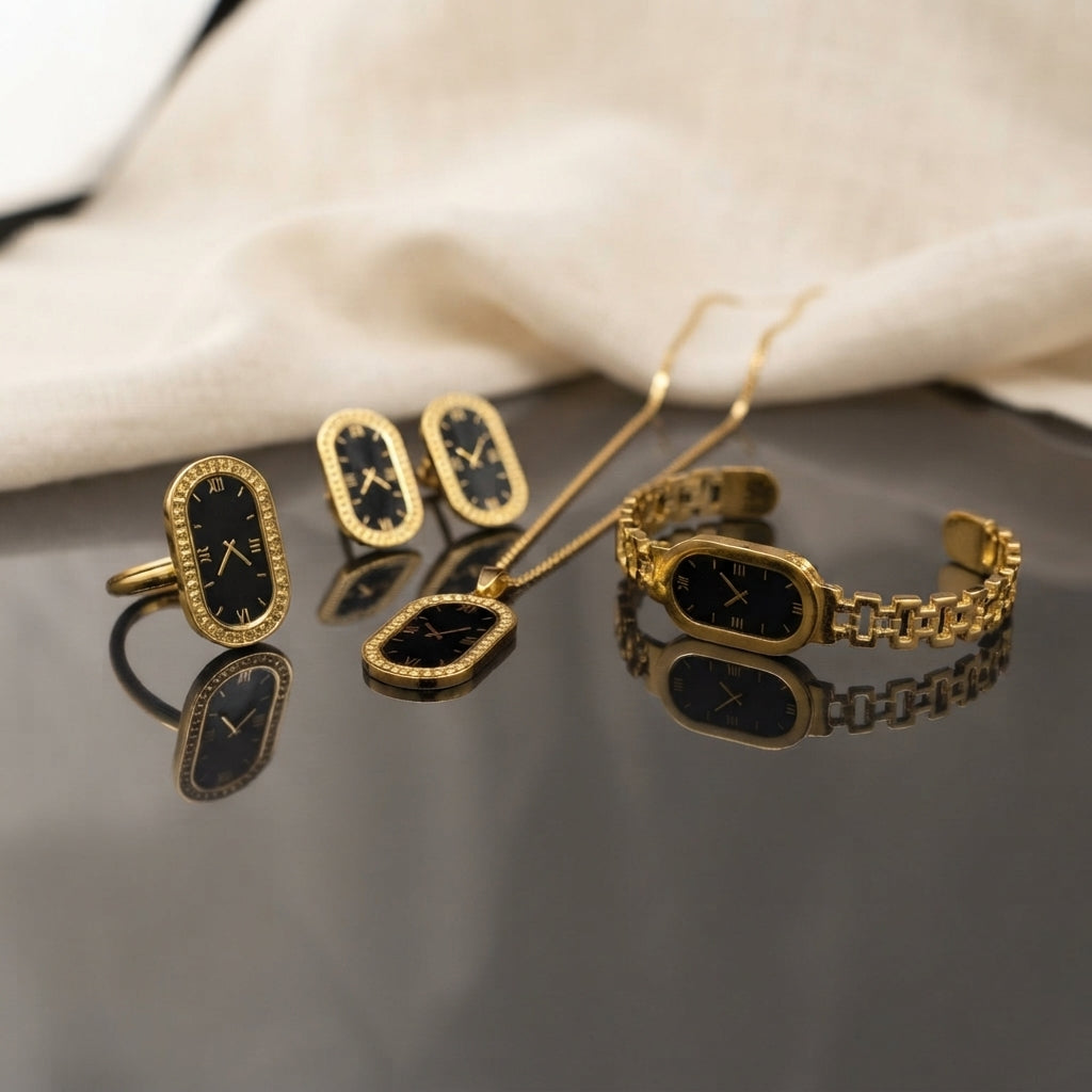 Gold Black Enamel Roman Numeral Clock Face 4-Piece Jewelry Set flat lay on dark grey mirror surface with cream silk backdrop showing full set of micro-pave CZ ring open frame stud earrings pendant necklace and president-link cuff bracelet all with black enamel Roman numeral clock face design with mirror reflections below
