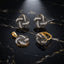 Gold-Tone Black & White CZ Quatrefoil Clover 3-Piece Jewelry Set — pendant, earrings and ring on black marble surface