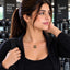 Gold Butterfly Black Onyx Disc Pendant Necklace worn by model in black gym jacket at gym setting with dumbbell rack backdrop