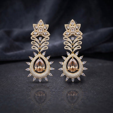 Gold Champagne CZ Lotus Crown and Pear Halo Sunburst Marquise Drop Earrings on dark mirror surface with charcoal backdrop showing 22K warm gold-tone grand drop earring pair with large lotus crown marquise white CZ petals open feather palm frond micro-pave champagne CZ connector and grand champagne morganite pear CZ halo pendant with double-row halo and outer marquise white CZ sunburst fringe