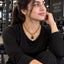 Gold Cuban Chain Emerald CZ Square Pendant Toggle Necklace worn by model in black outfit at gym setting