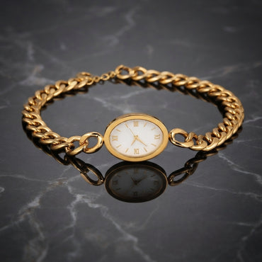 Gold Cuban Link Chain Oval Bracelet Watch in 18K gold-tone PVD stainless steel on dark grey marble surface showing bold Cuban curb link chain bracelet with smooth oval landscape gold-tone watch case and decorative white Roman numeral watch-face dial sticker with slim gold-tone hands and mirror reflection below