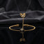 Gold CZ Bezel Double Chevron Arrow Ring Slave Hand Chain Bracelet luxury product flat-lay displayed on transparent stand showing double chevron ring at top and bezel CZ bracelet below on dark charcoal silk backdrop