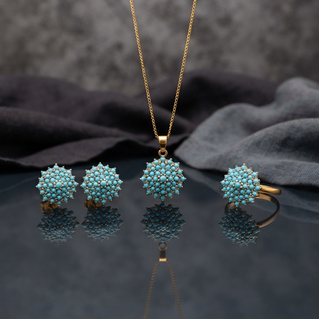 Gold CZ Cluster Dome 3-Piece Jewelry Set in Turquoise showing pendant necklace on gold cable chain stud earrings and adjustable ring all with fully domed turquoise round cabochon stone cluster in gold-tone prong setting on grey mirror surface with grey silk backdrop