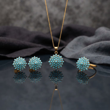 Gold CZ Cluster Dome 3-Piece Jewelry Set in Turquoise showing pendant necklace on gold cable chain stud earrings and adjustable ring all with fully domed turquoise round cabochon stone cluster in gold-tone prong setting on grey mirror surface with grey silk backdrop