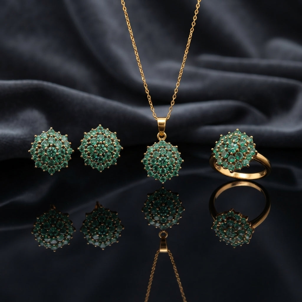 Gold CZ Cluster Dome 3-Piece Jewelry Set in Ruby Red showing pendant necklace on gold cable chain stud earrings and adjustable ring all with fully domed ruby red faceted CZ stone cluster with white CZ accent stones in gold-tone prong setting on dark mirror surface with dark silk backdrop