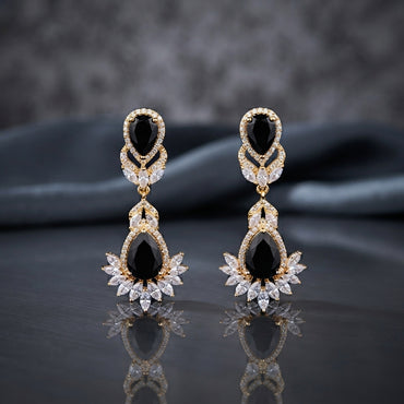 Gold CZ Double Teardrop Marquise Fan Chandelier Earrings in Ruby Red pair on black mirror surface with dark backdrop showing 18K gold-tone small ruby red pear CZ stud with white CZ pave halo infinity connector and large ruby red pear CZ drop with white CZ pave halo and marquise CZ fan crown with mirror reflection below