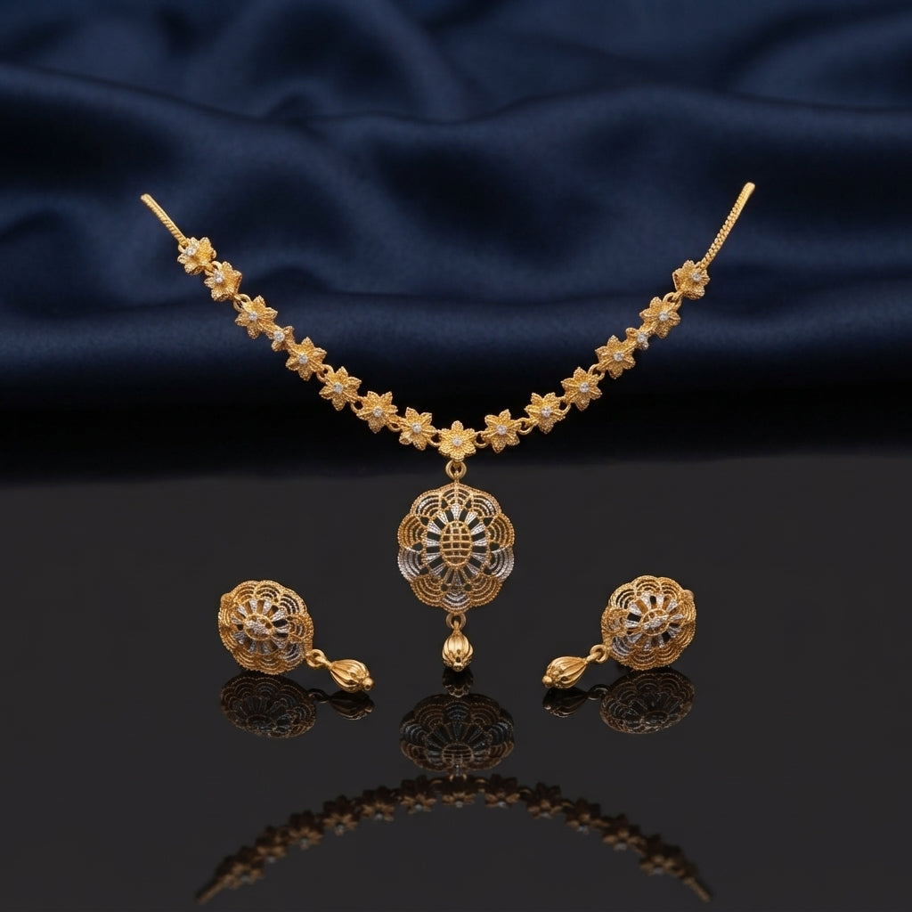 Gold CZ Filigree Lotus Floral Pendant Necklace and Tulip Drop Earrings Set — 22K antique gold-tone 2-piece set with continuous 6-petal daisy star flower station necklace large 3-layer scalloped petal open filigree lotus pendant with CZ micro-pavé accents and tulip gold drop and matching round dome filigree tulip drop earrings displayed on dark mirror surface with navy blue satin backdrop
