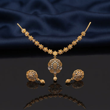 Gold CZ Filigree Lotus Floral Pendant Necklace and Tulip Drop Earrings Set — 22K antique gold-tone 2-piece set with continuous 6-petal daisy star flower station necklace large 3-layer scalloped petal open filigree lotus pendant with CZ micro-pavé accents and tulip gold drop and matching round dome filigree tulip drop earrings displayed on dark mirror surface with navy blue satin backdrop