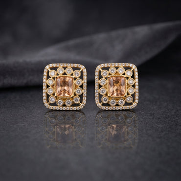 Gold CZ Open Filigree Rectangle Frame and Solitaire Stud Earrings in Mint Green worn by model with teal green outfit showing 22K gold-tone open rectangular filigree stud earring with mint green emerald-cut CZ centre on ear lifestyle shot