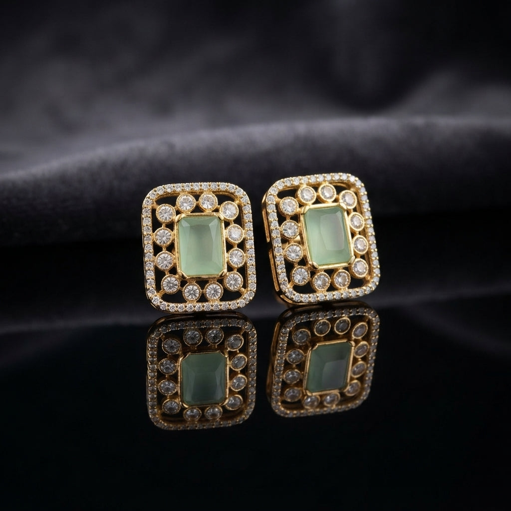 Gold CZ Open Filigree Rectangle Frame and Solitaire Stud Earrings in Champagne on dark slate surface with charcoal satin backdrop showing 22K gold-tone open rectangular filigree frame with micro-pave CZ border large round white CZ bezel solitaires and warm champagne morganite cushion CZ centre stone