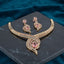 Gold CZ Peacock Feather Leaf Torque Necklace & Drop Earrings Set in Pink Rose CZ on dark grey marble with teal velvet backdrop