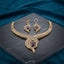 Gold CZ Peacock Feather Leaf Torque Necklace & Drop Earrings Set in Purple Amethyst CZ on dark grey marble with teal velvet backdrop