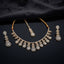 Gold CZ Pear Fringe Necklace Maang Tikka and Linear Drop Earrings Bridal Set — 22K gold-tone 3-piece bridal set with graduating pear CZ halo fringe necklace with marquise leaf clusters and traditional red thread spine matching maang tikka with pear CZ halo drop and 3-tier linear drop earrings displayed on dark black satin surface with mirror reflection