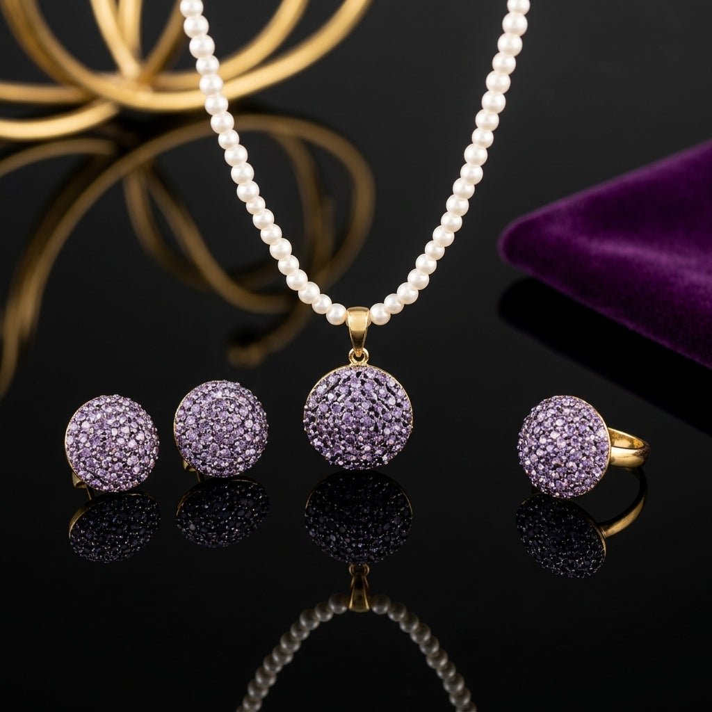 Gold-Tone 3D Dome Ball Pavé Amethyst Purple CZ Pearl Chain Necklace, Earrings & Ring Jewelry Set on black reflective surface with purple velvet jewelry box and gold lotus ornament backdrop