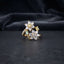 Gold Double Flower Cluster CZ Cocktail Ring in yellow citrine and mint green CZ accent variant — luxury flat-lay on stone surface with dark silk backdrop